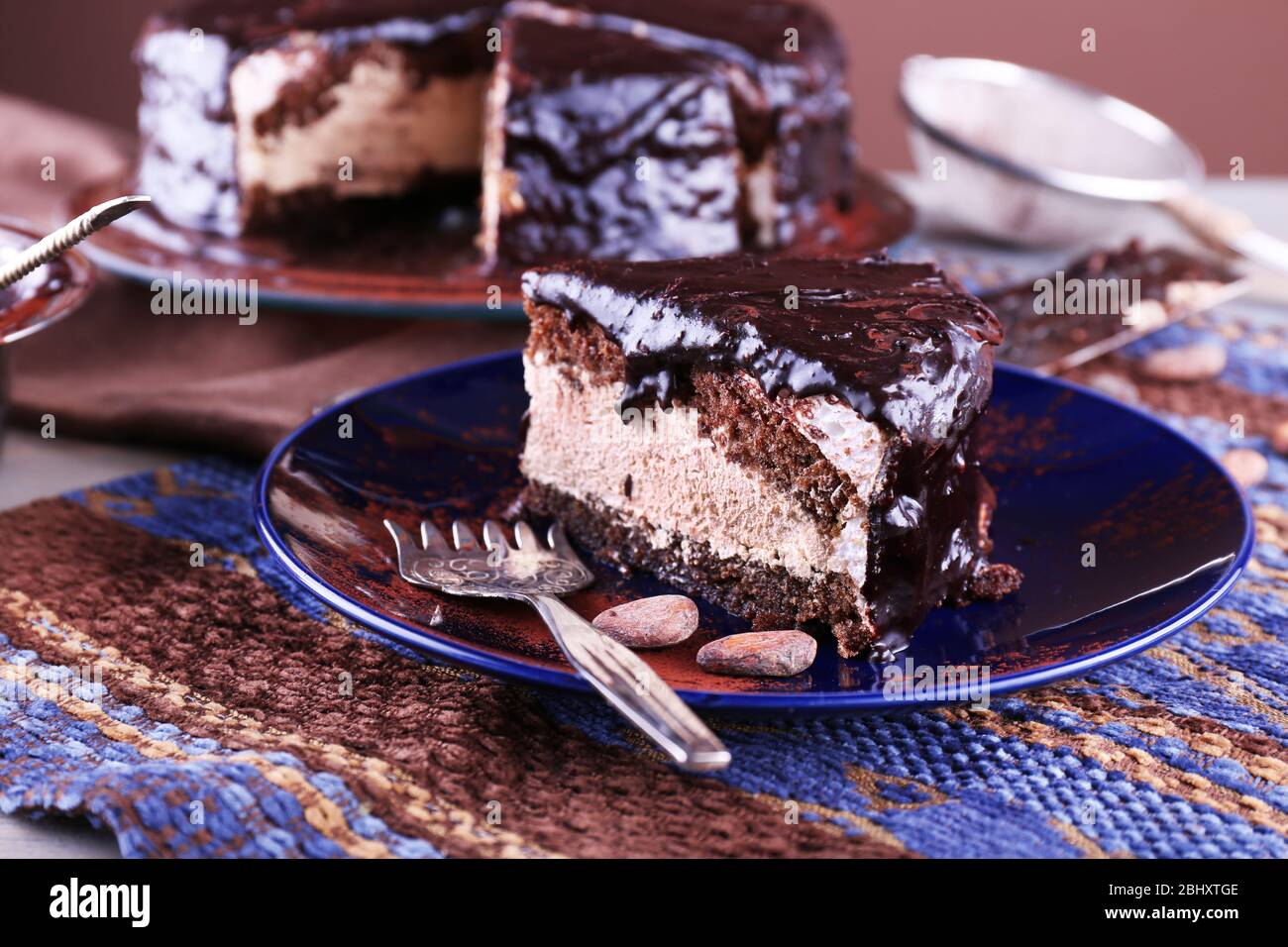 Delicious chocolate cake with icing in plate on table, closeup Stock ...