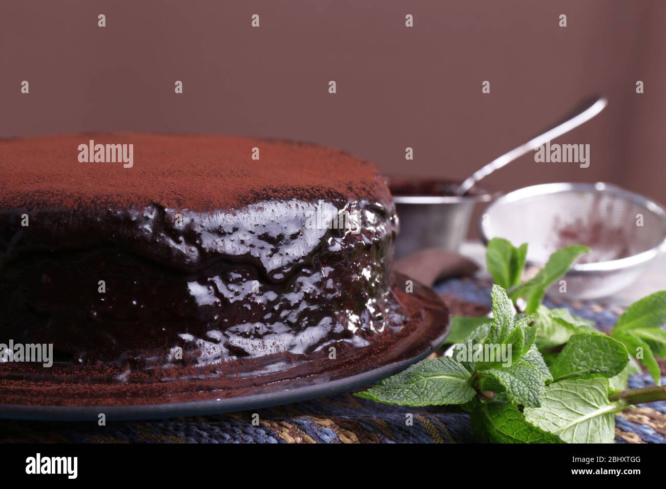 Delicious chocolate cake with icing in plate on table, closeup Stock ...