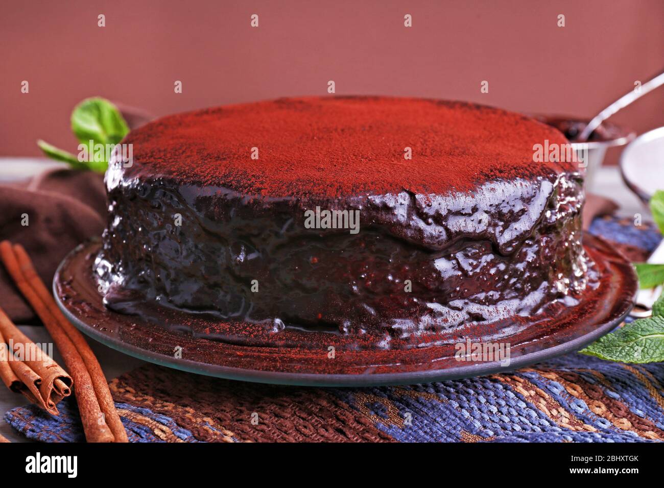 Delicious chocolate cake with icing in plate on table, closeup Stock ...