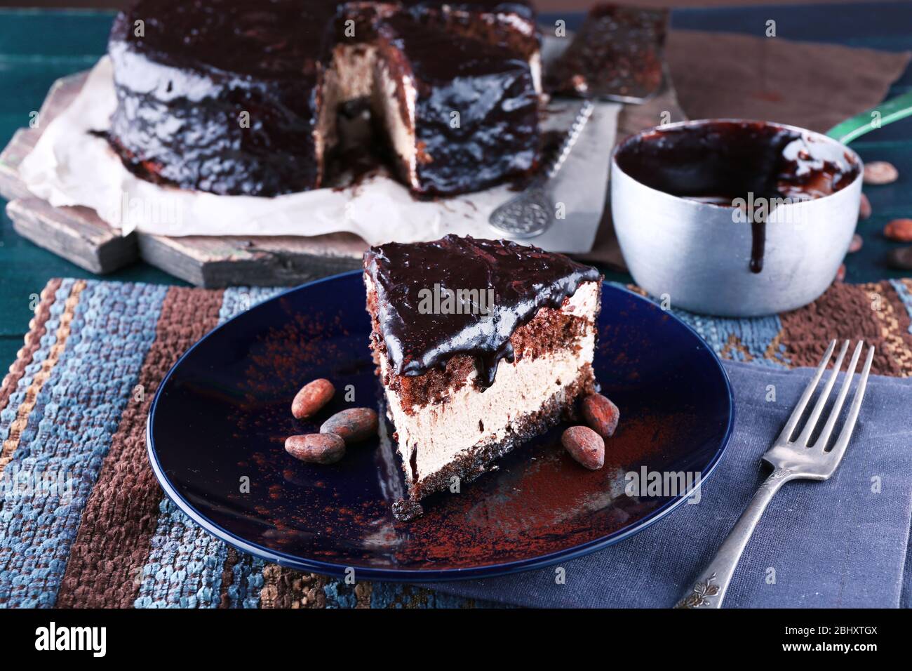 Delicious chocolate cake with icing in plate on table, closeup Stock ...