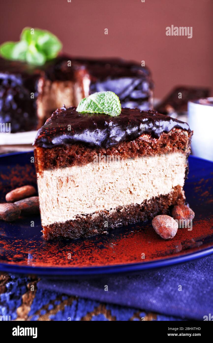Delicious chocolate cake with icing in plate on table, closeup Stock ...
