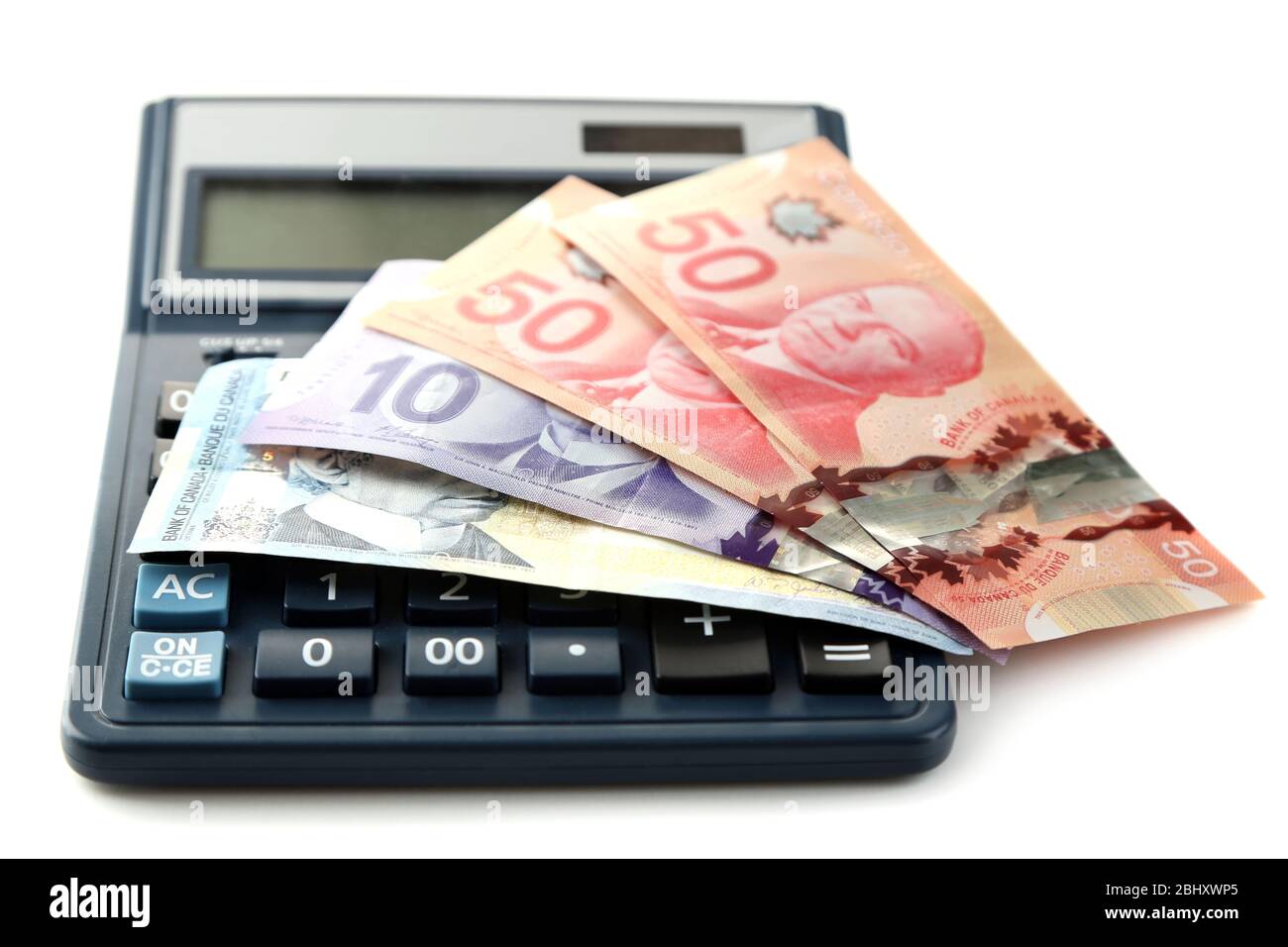 Calculator and Canadian dollars, isolated on white Stock Photo Alamy