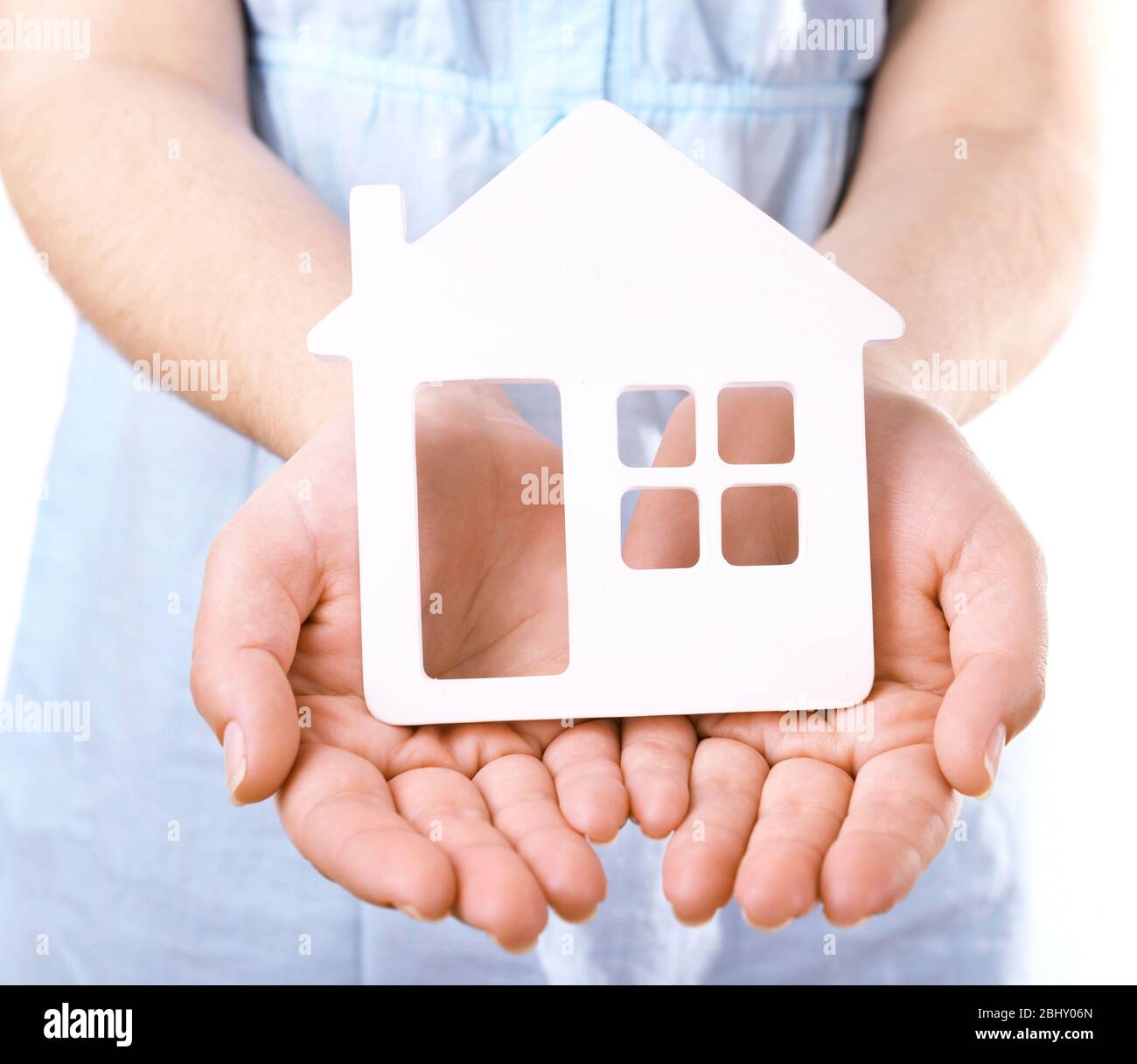 Female hands with small model of house isolated on white Stock Photo ...