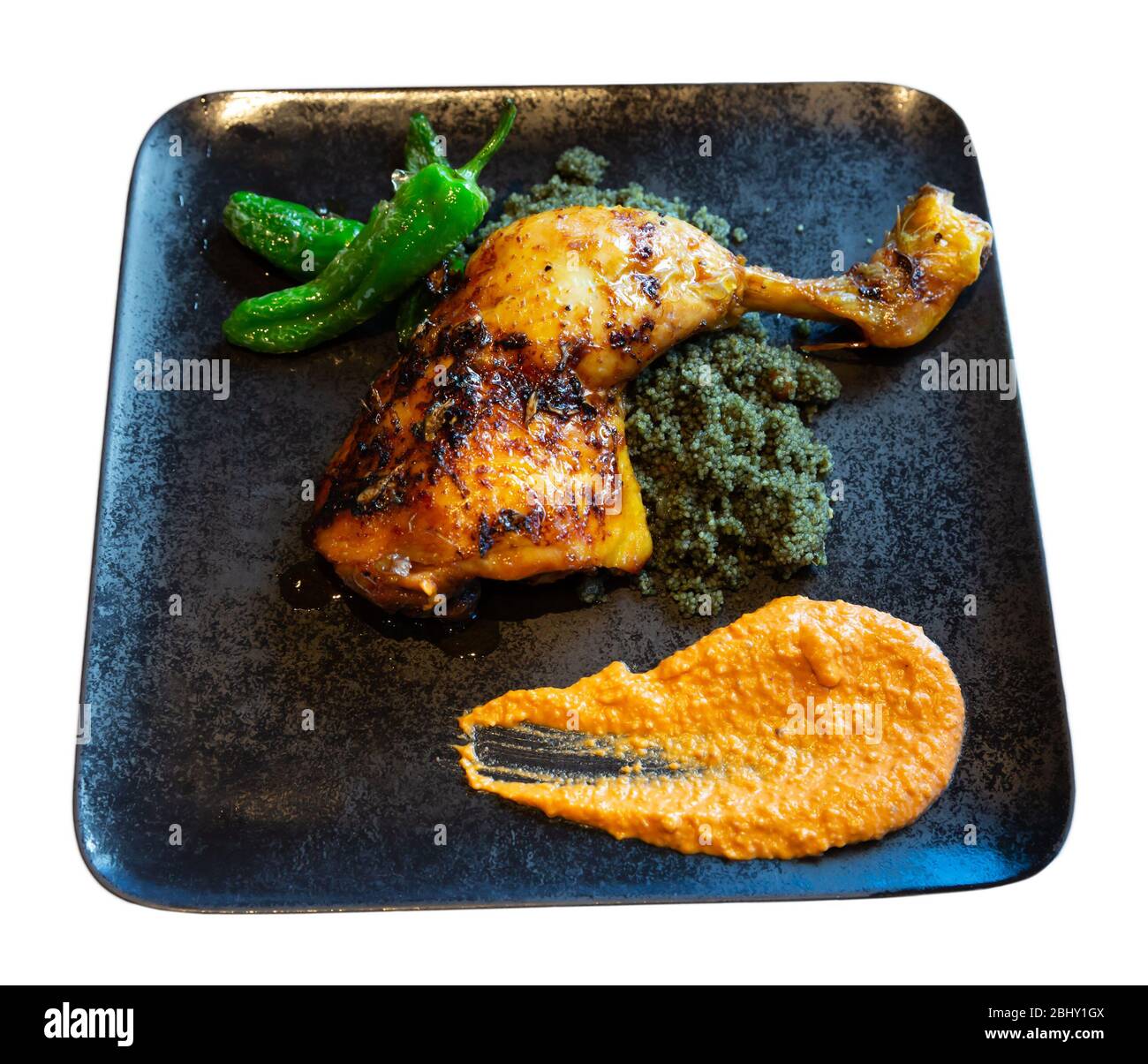 Baked chicken drumstick with garnish of couscous with black curry