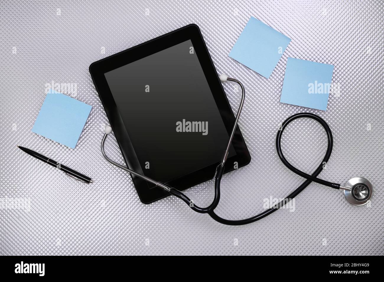 Medical tablet with stethoscope on white background Stock Photo - Alamy
