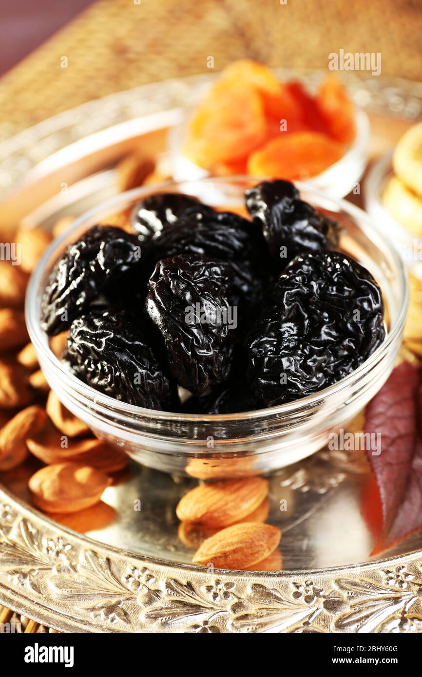 Pile of prunes in glass saucers with grape leaves, closeup Stock Photo Alamy