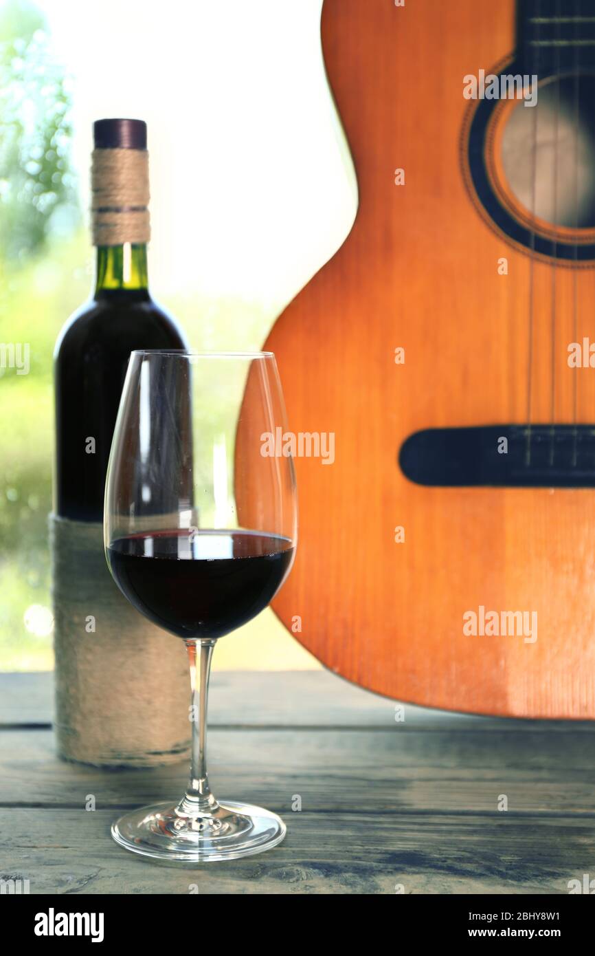 Acoustic guitar and glass of wine next the window with rain drops Stock  Photo - Alamy