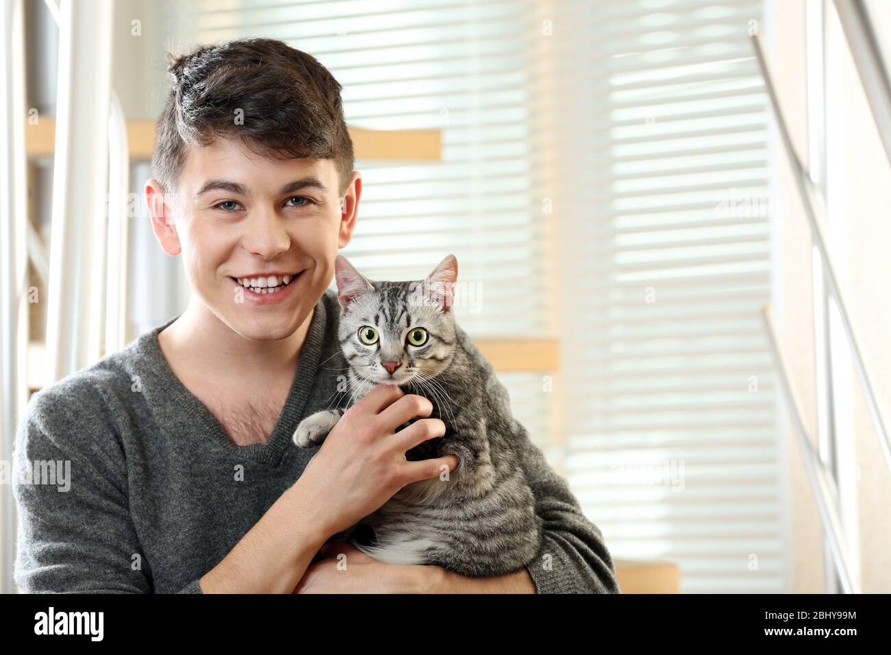 Male model holding cat hi-res stock photography and images - Alamy