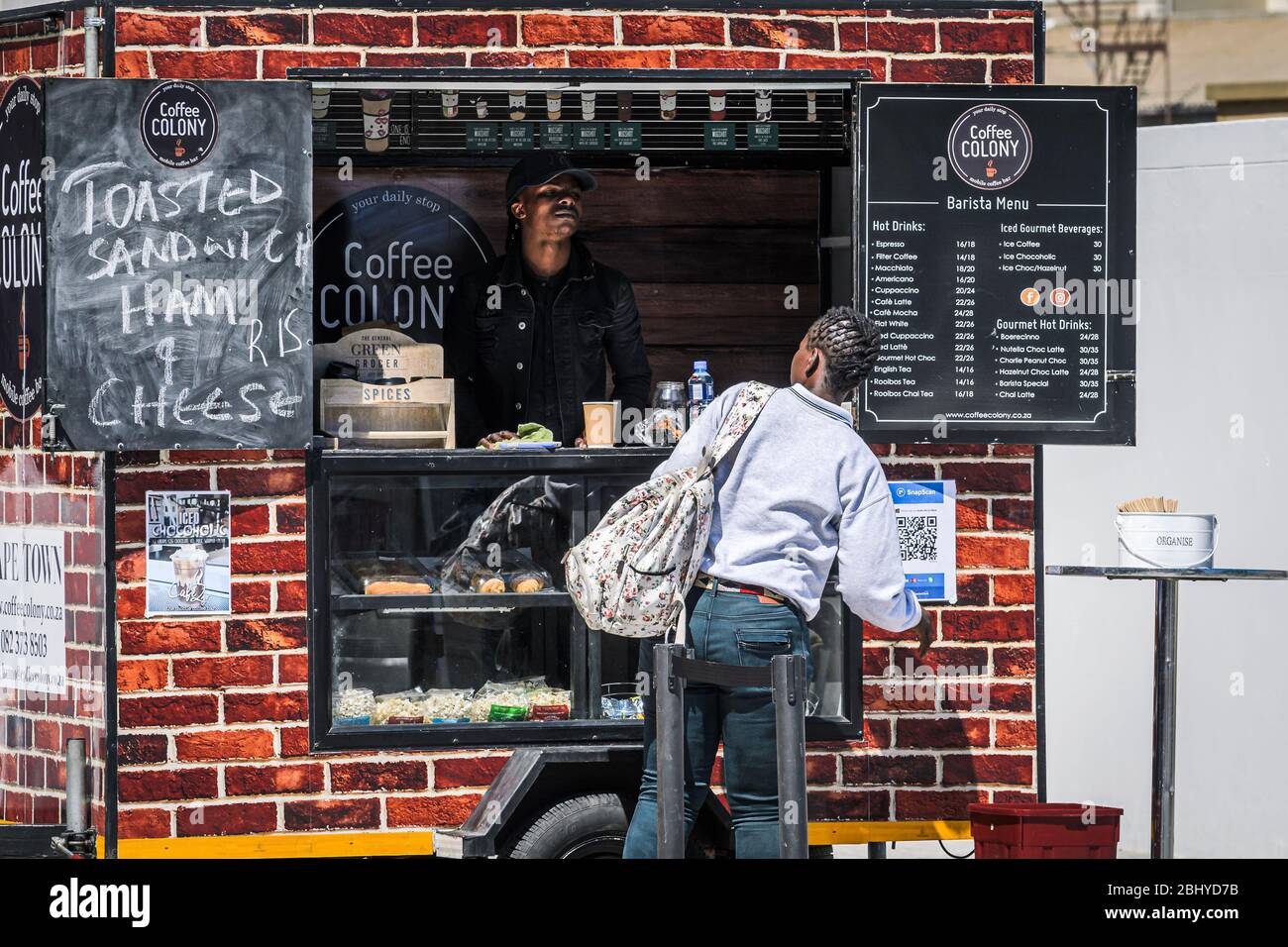 African coffee colony street vendor serving customer food and drinks from mobile street stall Cape town South Africa Stock Photo