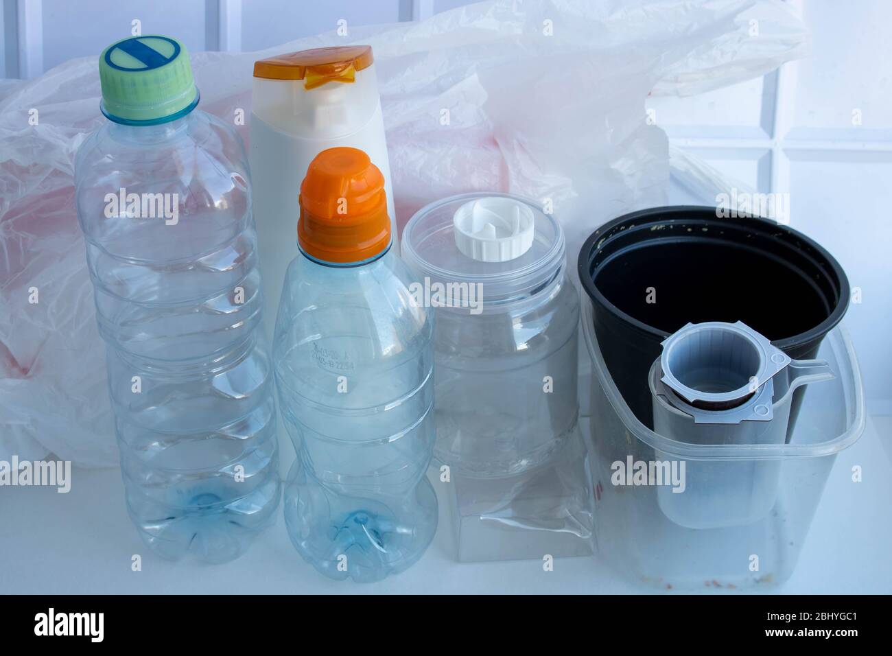 Plastic containers on a white background. The processing of plastics