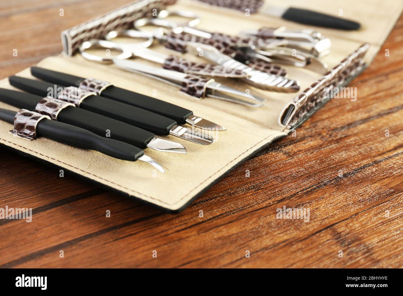 Manicure set in open case on wooden table, closeup Stock Photo
