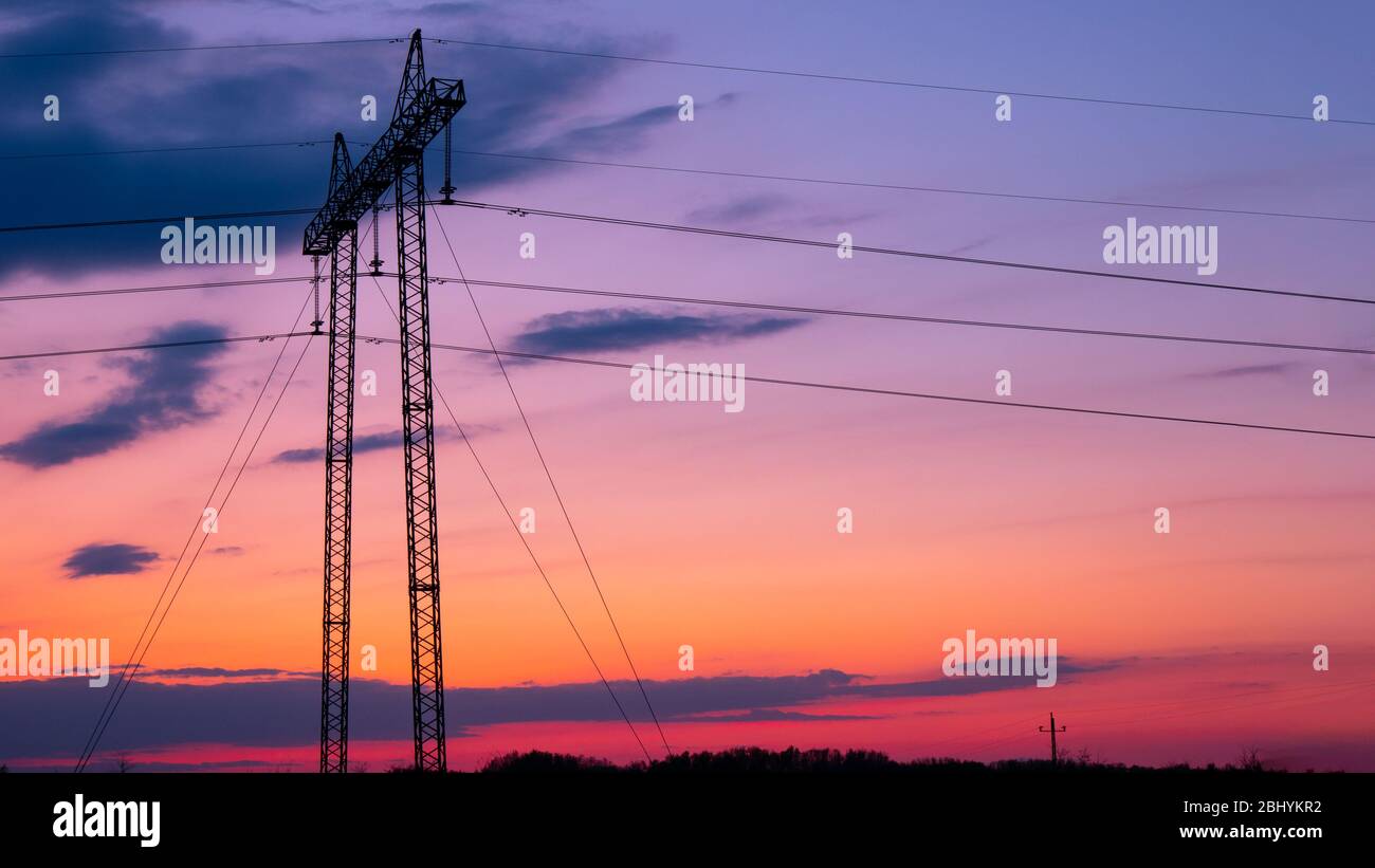 Silhouette of high voltage electric tower at beautiful sunset Stock ...