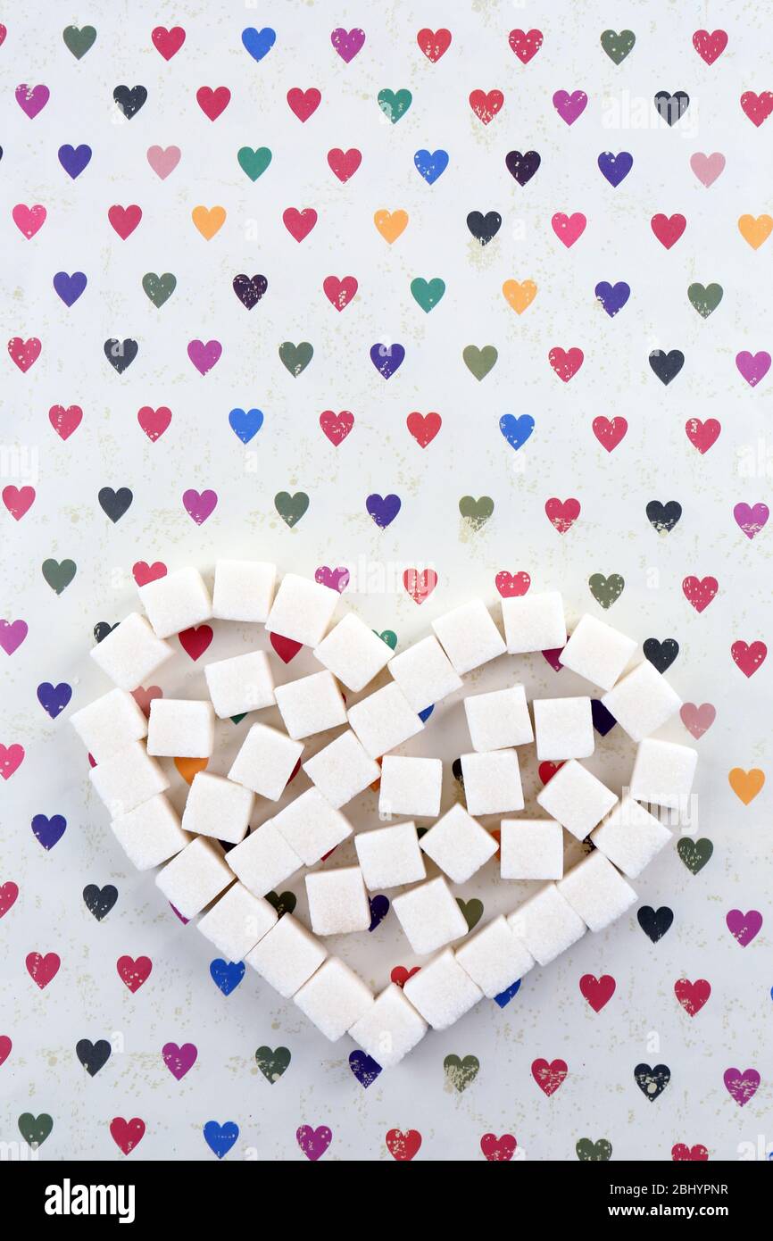 Sugar cubes in heart shape on paper background Stock Photo - Alamy