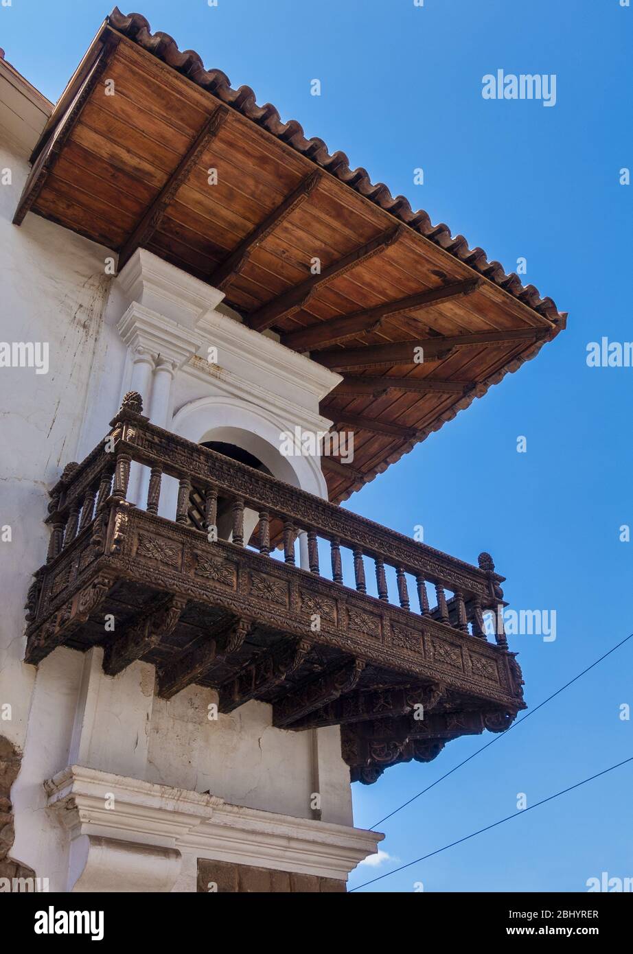 Decorative carved wooden balcony dating back to the Spanish colonial era in the city of Cusco, Peru Stock Photo