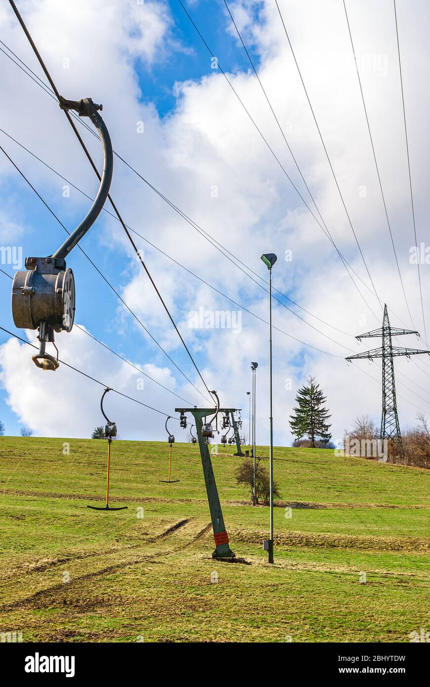 Ski lifts are at a standstill at the end of winter due to snow-free slopes caused by climate change. Stock Photo