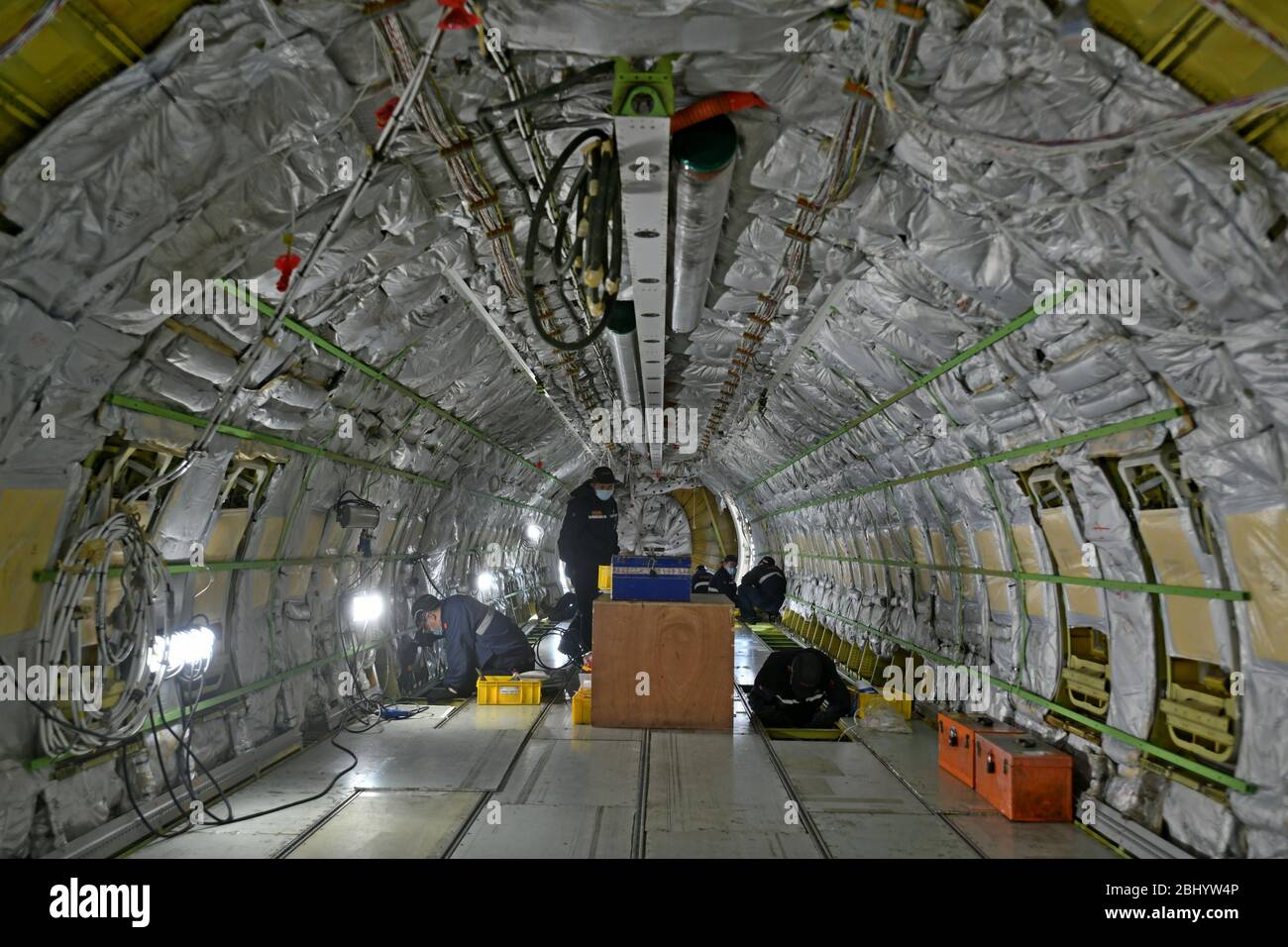 (200428) -- JINAN, April 28, 2020 (Xinhua) -- Technicians refit an airliner at Taikoo (Shandong) Aircraft Engineering Company Limited (STAECO) in Jinan, east China's Shandong Province, April 27, 2020.  The COVID-19 pandemic has led to a significant decrease in airline travel and passenger revenue. Since its production recovered on Feb. 10, STAECO has been offering Passenger-to-Freighter (PTF) solutions for airline operators which need more cargo planes to address this market change. So far, the company has accomplished three PTF conversions for its clients. (Xinhua/Zhu Zheng) Stock Photo