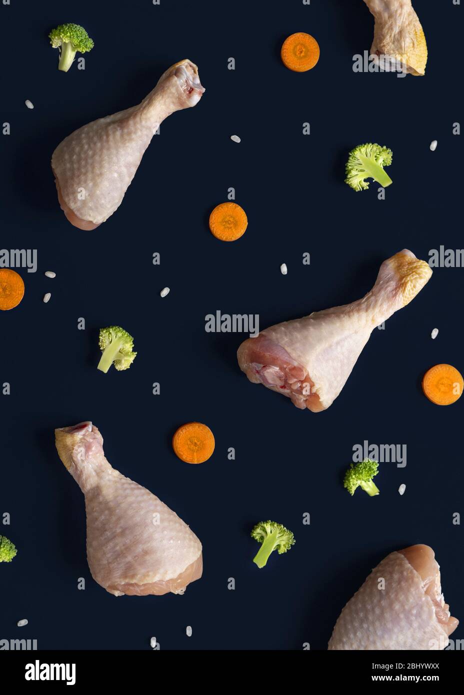 Concept of diet food. Flat lay composition pattern of chicken thigh, broccoli, carrots and rice grains Stock Photo