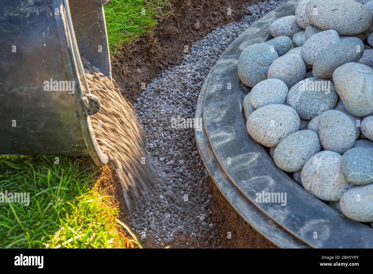 gritting material filled into the curb of a garden fountain Stock Photo