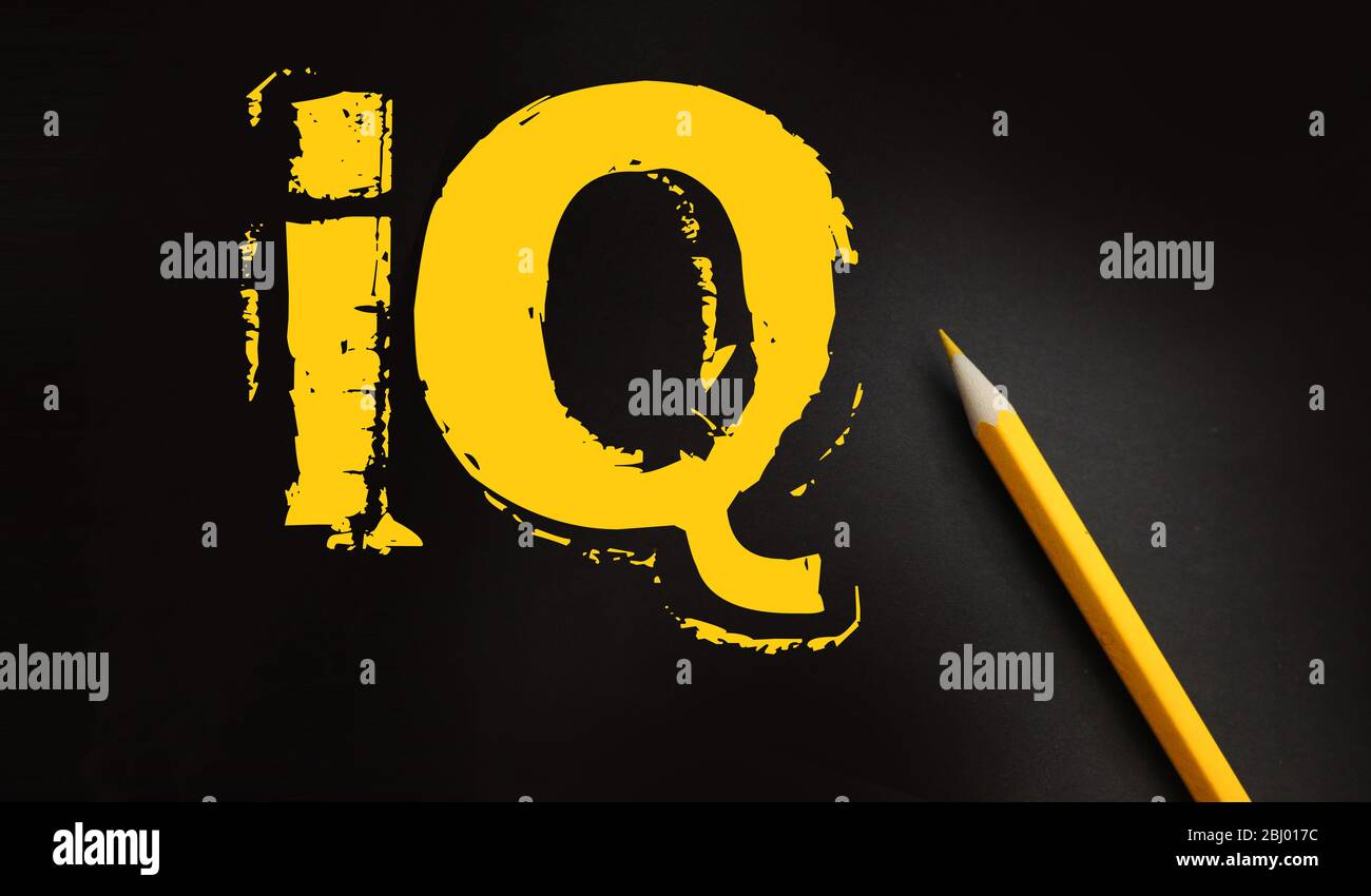 IQ text yellow on black and pencil besides. Intellectual test intelligence quotient education concept Stock Photo