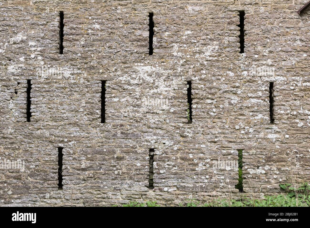 Ventilation slits in the wall of an old stone barn, Herefordshire, UK Stock Photo