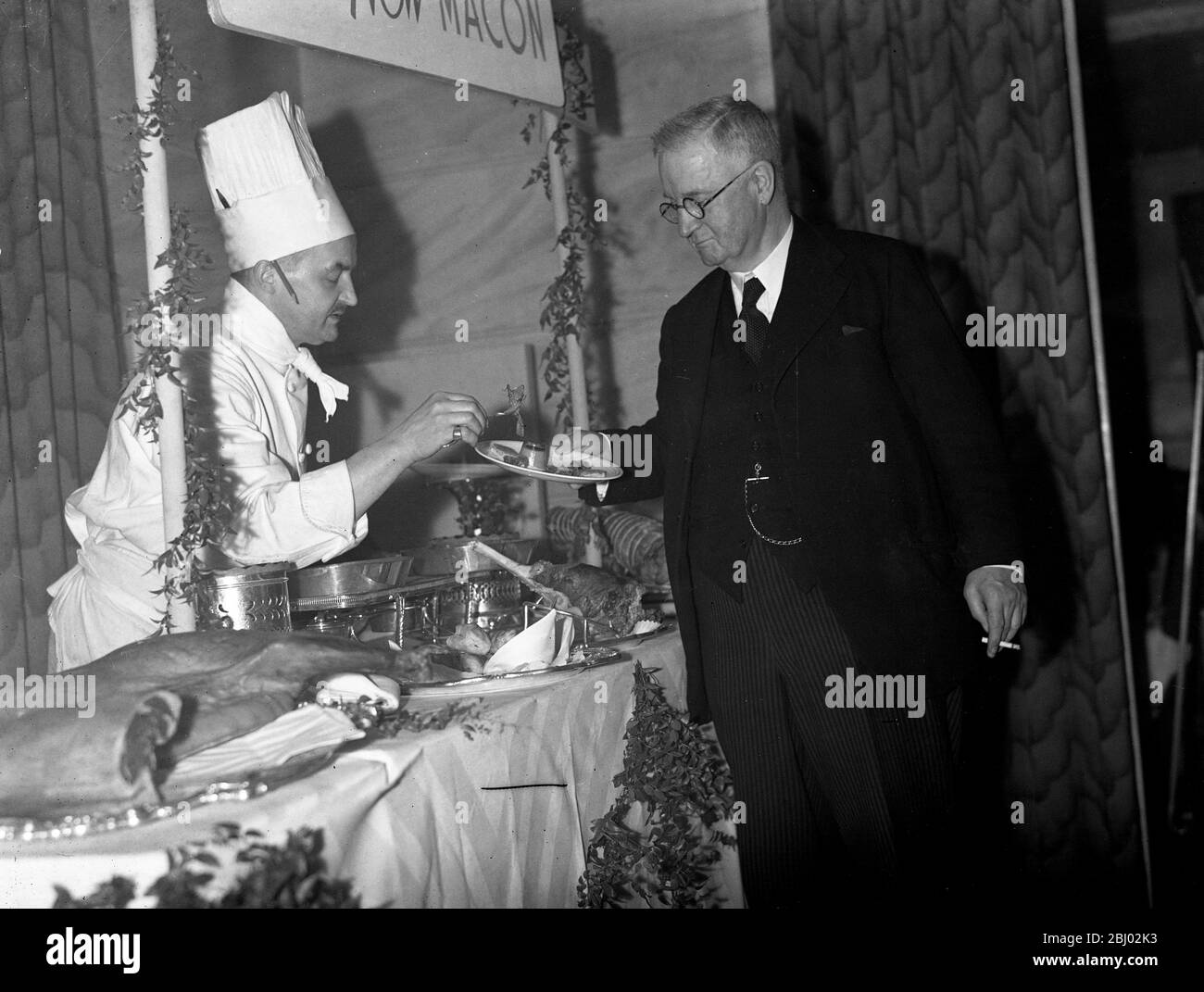 A war time measure to overcome the bacon shortage is a campaign to popularise the old Scottish dish of macon ( mutton , treated as bacon ) . - Mr F A Macquisten , M P , samples a portion at the savoy . Stock Photo