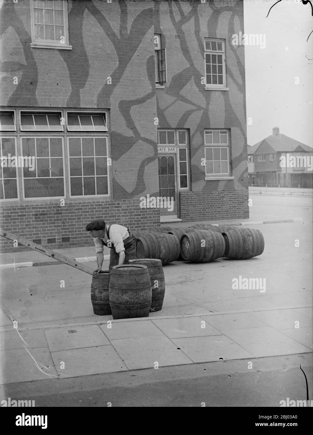 Taking in a barrel delivery outside The Northover , a camouflaged public house in Downham near London . - 1939 - Stock Photo