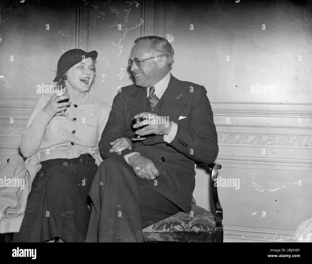 Miss Victoria Hopper to marry Mr Basil Dean , the producer . - The engagement is announced of Miss Victoria Hopper , the actress and Mr Basil Dean , the producer , author and actor , who discovered her in 1933 . - Photo shows , Mr Basil Dean and Miss Victoria Hopper , toasting each other ' s health after the announcement of their engagement . - 18 April 1934 . - - 30s, 30's, 1930s, 1930's, thirties, nineteen thirties Stock Photo