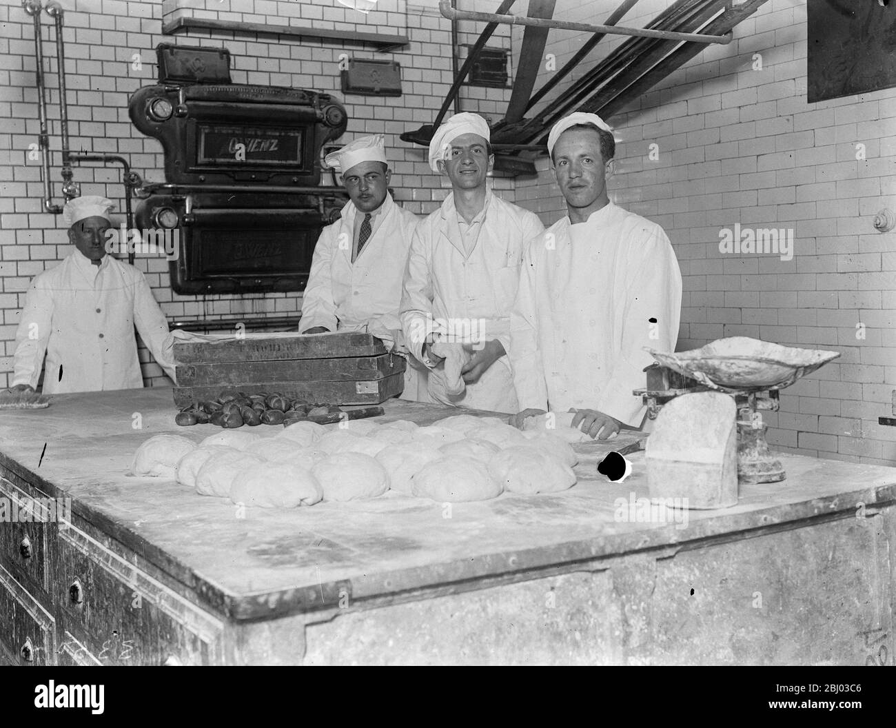 Viennese bakers begin work in London . 5 , 000 rolls a day for exhibition . - Four Viennese bakers are producing 5 , 000 rolls and loaves everyday at the National Austrian exhibition , which has opened at the Dorland Hall , London . They have received special Home Office permits to spend a month in London at work for the Viennese Cafe in the Exhibition . The exhibition is the first Austria has held in London since 1906 . - Photo shows , the Austrian bakers at work in the bakehouse in South East London . - 15 April 1934 - 30s, 30's, 1930s, 1930's, thirties, nineteen thirties Stock Photo