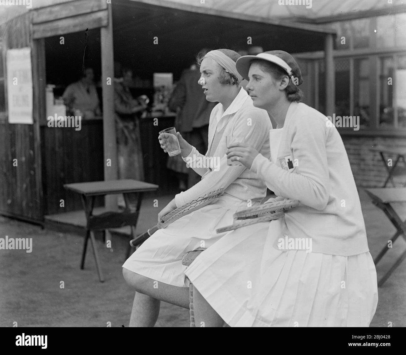 Miss Stammers wins singles final at Ealing. - Miss Stammers (nearer camera) and Miss Scott taking refreshment after the match. - 23 April 1932 Stock Photo
