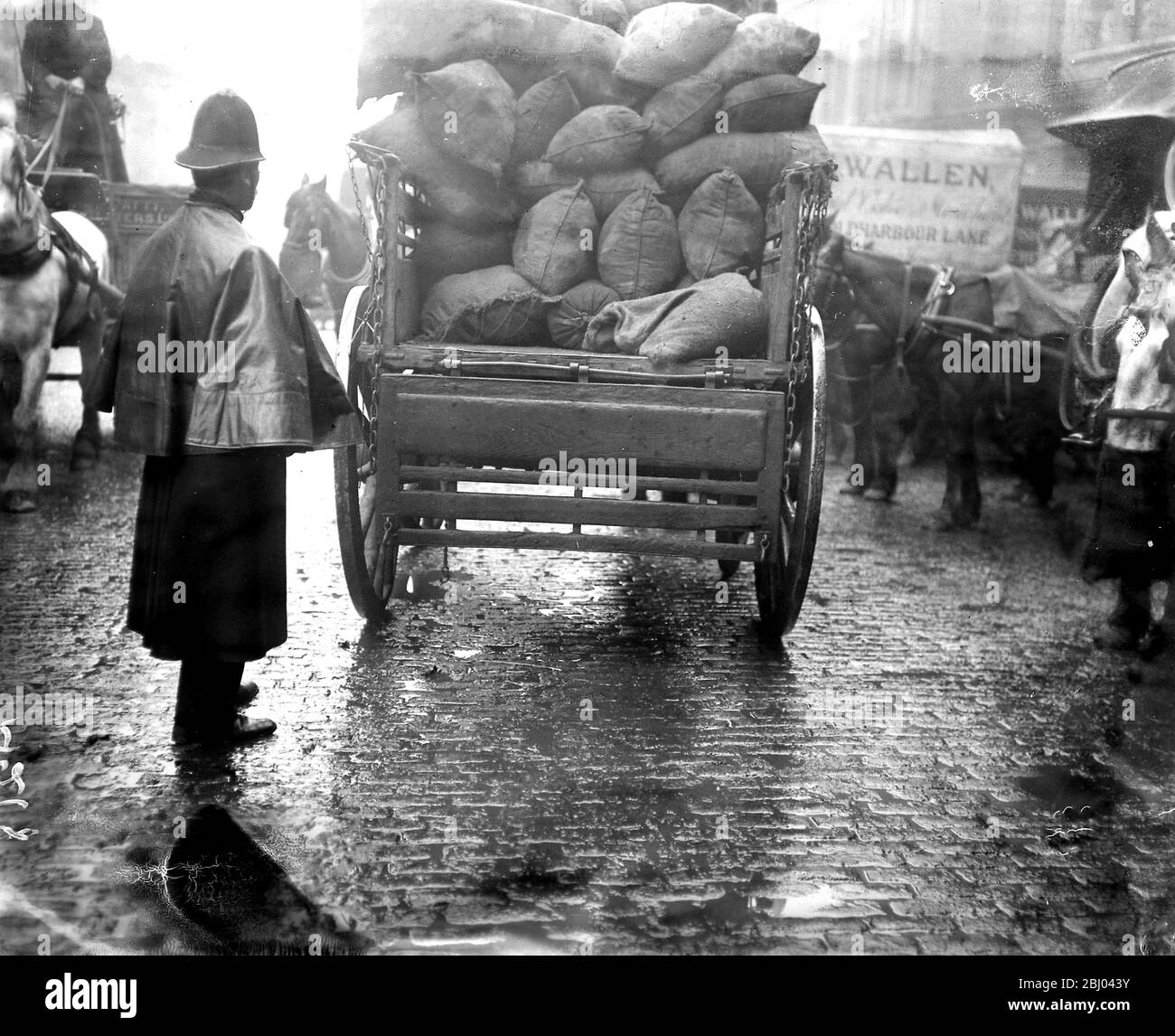 The potato shortage - Scene at Borough Market policman guarding the last van of potatoes. - 24th Feburary 1917 Stock Photo