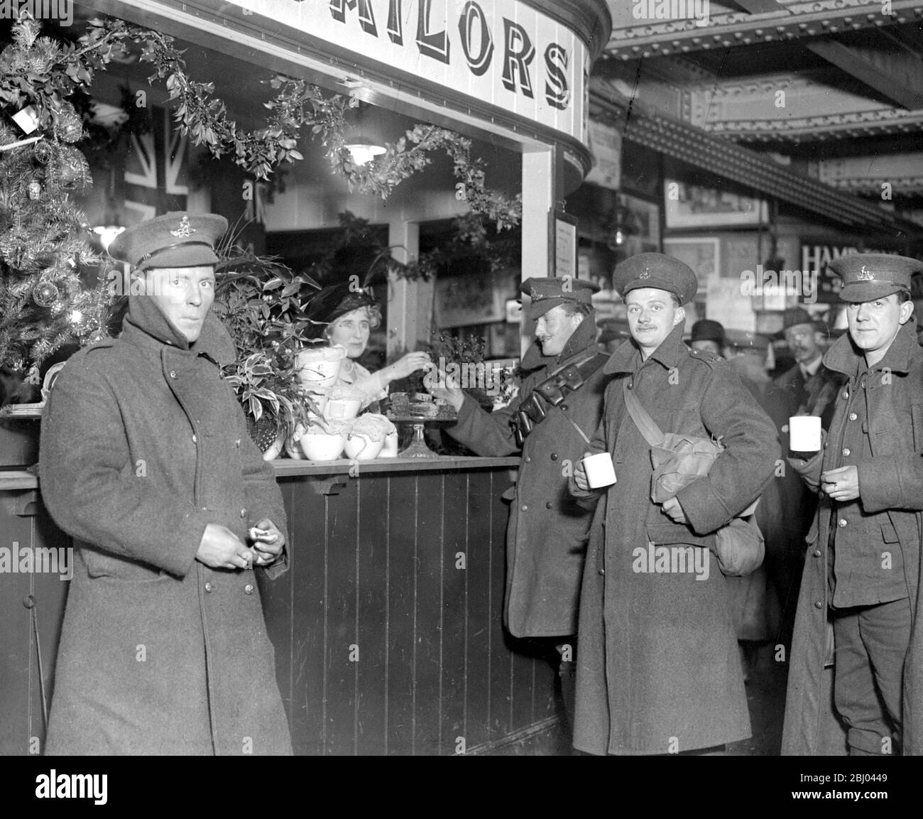 Soldiers arriving at and departing from London Bridge Station during the Christmas Holiday are served with a slice of christmas pudding. Stock Photo