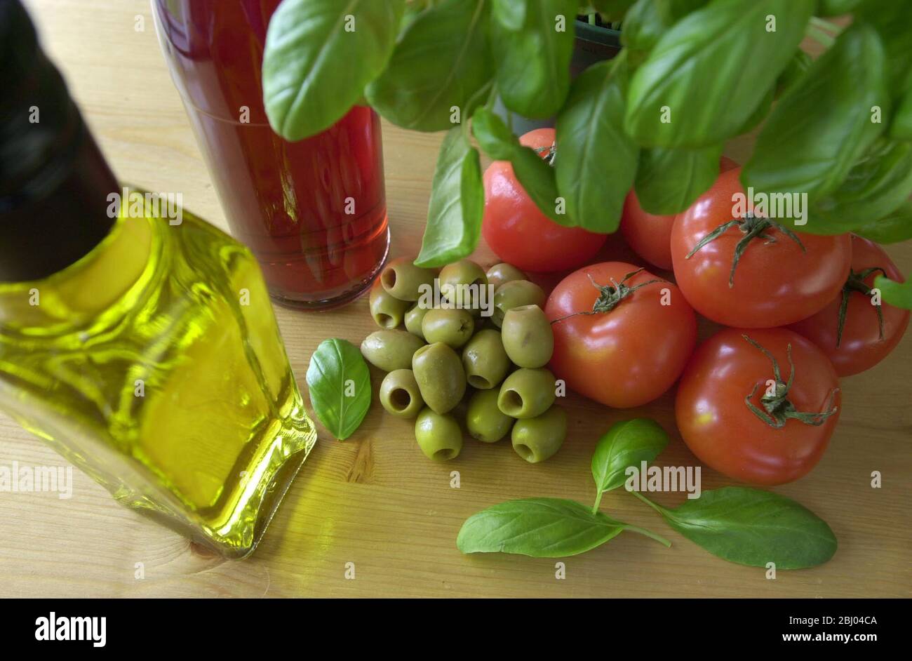 TOMATO AND OLIVE DIP WITH OLIVE OIL, RED WINE VINEGAR AND BASIL LEAVES. Stock Photo