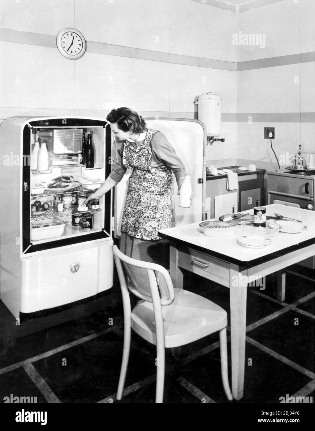 The English Electric company will show at the Ideal Home Exhibition 1949, their new 6.4 cubic ft. refrigerator, here seen in a modern kitchen. Stock Photo
