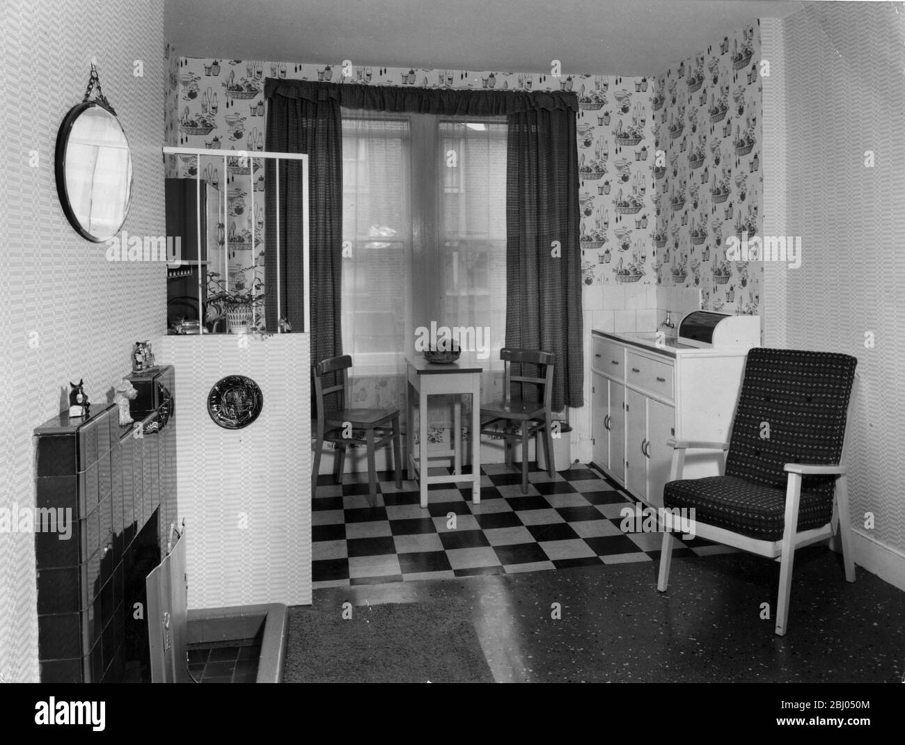 Kitchen units - Use of contrasting wallpapers to emphasise division of one room into living room and kitchen Stock Photo