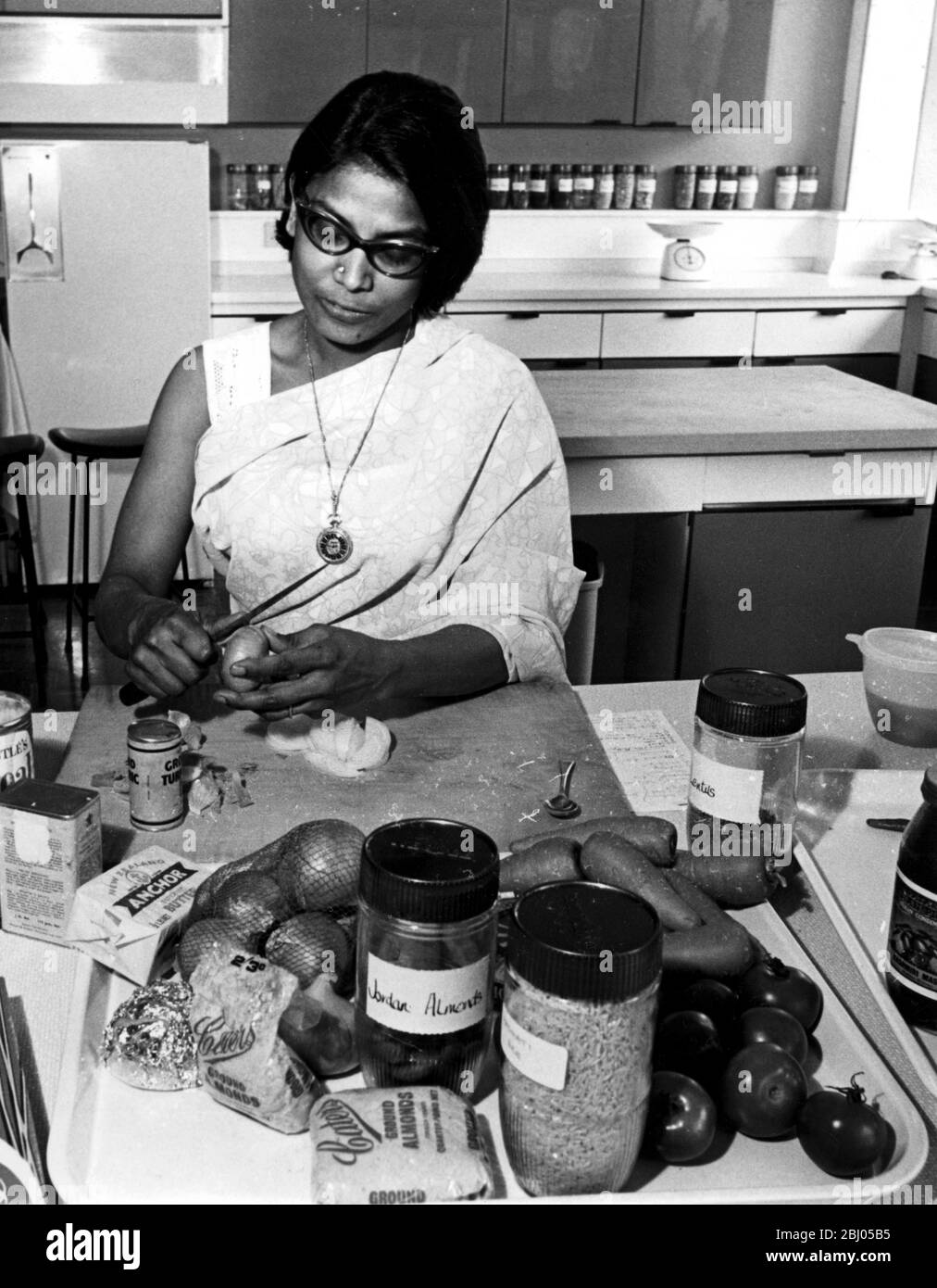 Mrs Mariyam Harris from Hyderabad in India cooks a dish from Recipes for Asians in Britain in the Food Information Centre kitchen - Stock Photo