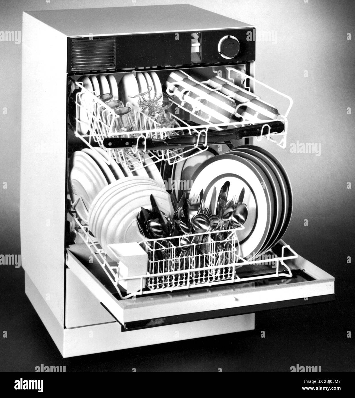 The Kim, a compact dishwasher designed specially for the UK, measures only 19 1/2 square and 23 1/2 high, yet takes the washing up for a family of six. It is fully automatic and costs 75 guineas. - May 1966 Stock Photo