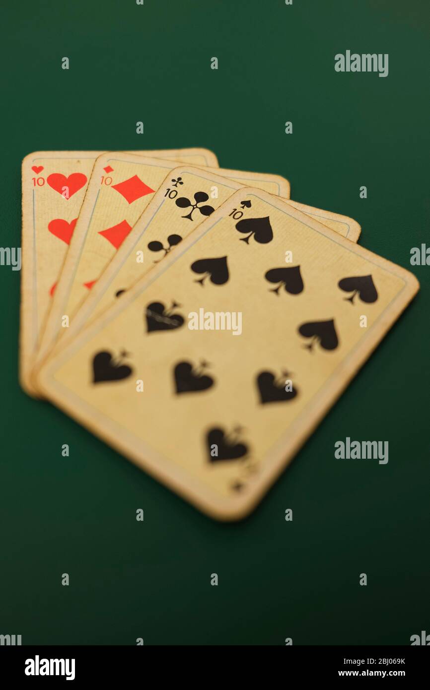 Playing cards on a green background Stock Photo Alamy