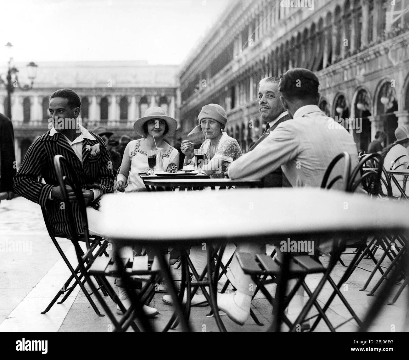 M. Diaghileff (right) with M. Serge and Mme. Sokolova taking tea in St Mark's Square, Venice, Italy. - 1920's Stock Photo