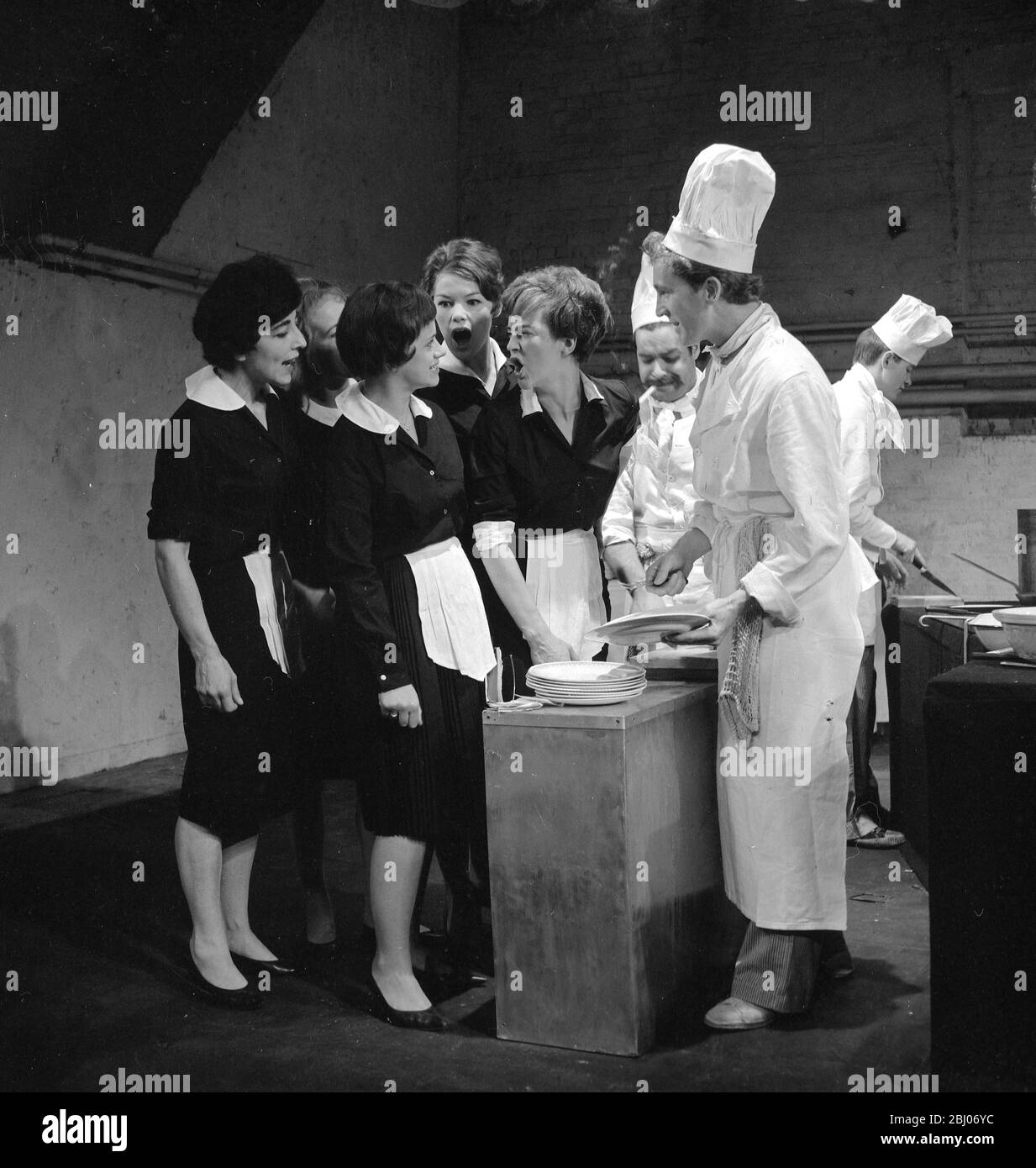 London: Scene from today's rehearsal of Arnold Wesker's play The Kitchen, directed by John Dexter, which returns to the London's Royal Court theatre, Sloane Square, for a further three weeks season this evening. - Setting of the play is the kitchen of a large restaurant, and here, the waitresses scream at each other in an attempt to get first service. - 21 August 1961 Stock Photo