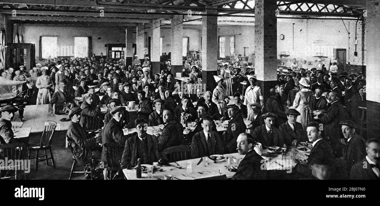 Welfare at work in the munitions factories in WWI. - Cheerful conditions that result in added efficiency : The midday meal in the canteen of a well-organised munitions factory . - Better results are obtained if the workers are well treated and conditions are cheerful and sympathetic . This is as true for men as for women. - Ministry of Munitions. - April 1917 - - - Stock Photo
