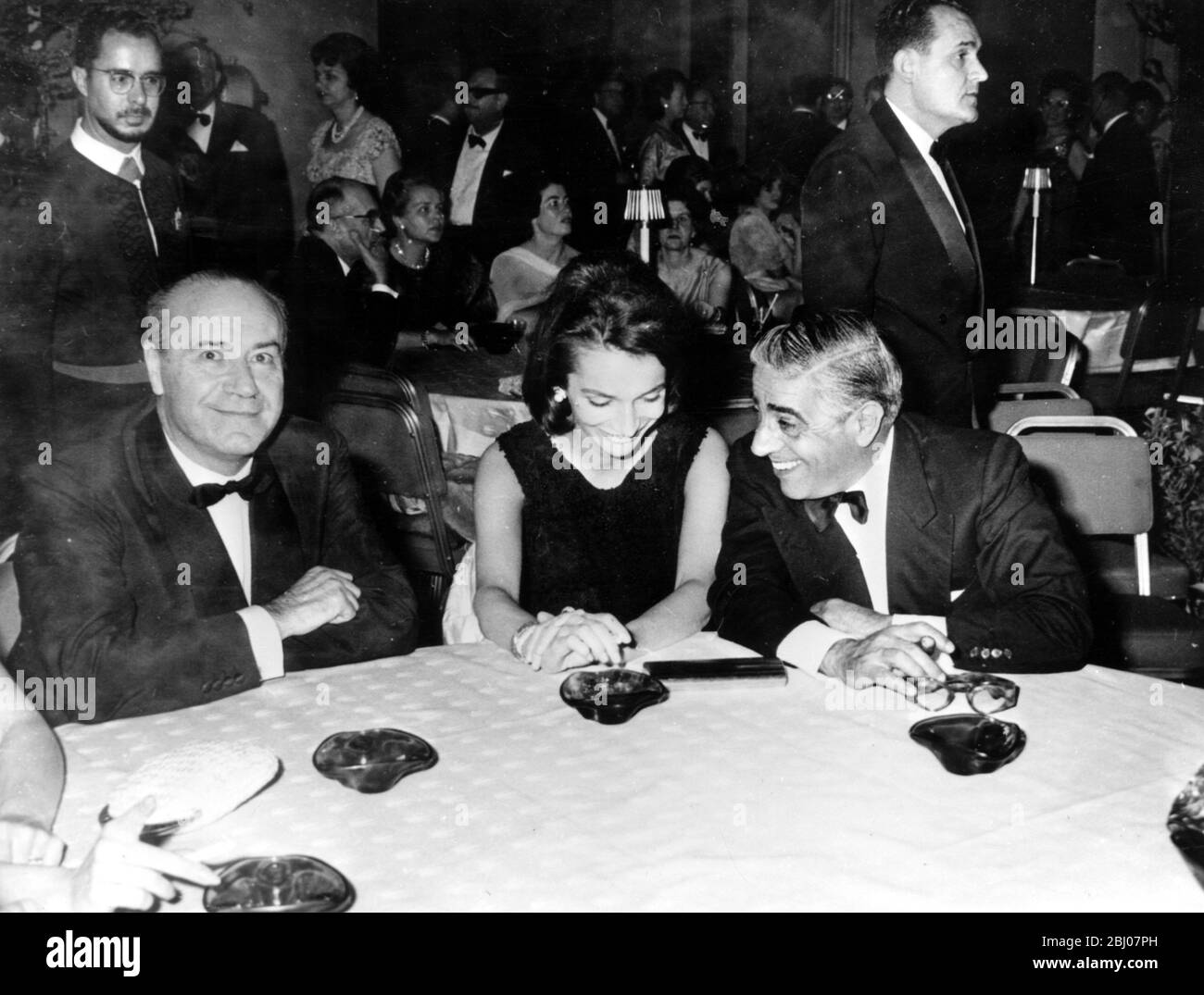 Pictured in the Terpsychore Hall of the luxurious Athens Hilton Hotel are LtoR Professor Stratis Andreades ; Princess Lee Radziwill , sister of Mrs Jacqueline Kennedy ; and Greek shipping magnate Aristotle Onassis . The three were attending a ball marking the opening of the newly built Athens Hilton . Professor Andreades is , besides being a well known ship owner , chairman of three large banks , chairman of the Greek Electric Railways , and financier . - 25 April 1963 Stock Photo