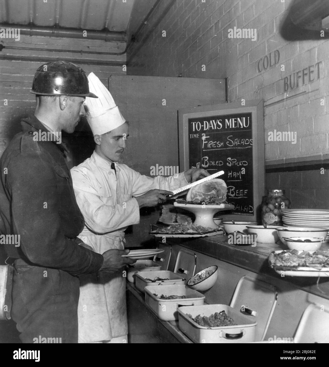 The canteen at Yorkshire's Manvers Main Colliery, near Dorchester where a one time West End chef cuts beef for a coal miner. - 16 December 1946 - Stock Photo