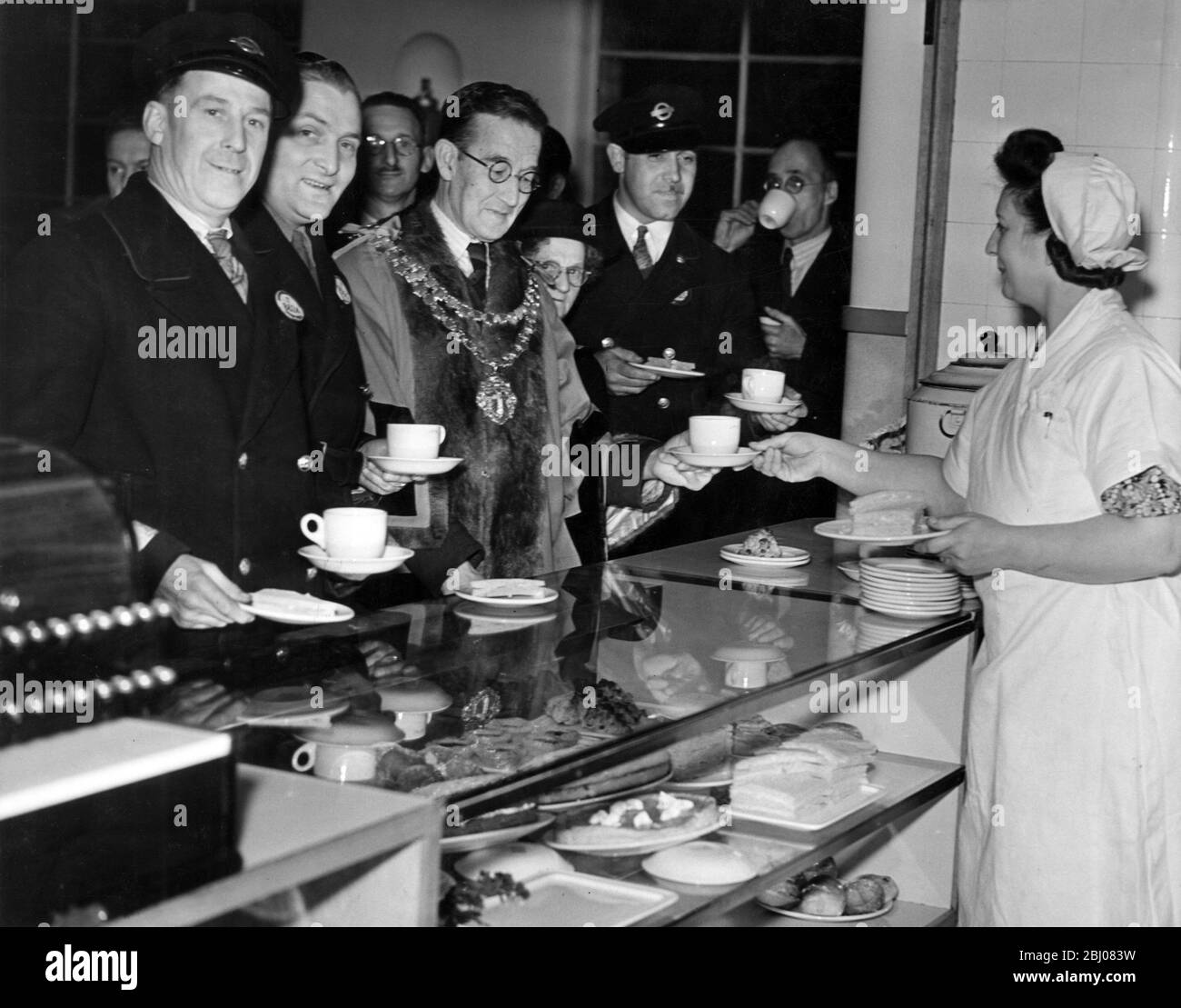 1000 London Transport men attached to the West Ham Trolleybus Depot have a new canteen which replaced the building which was bombed by a flying bomb. Alderman F.A. Warner was present to receive the first cup of tea. - London, England. - 29 October 1947 Stock Photo
