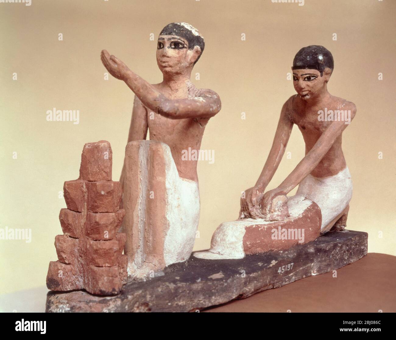 Tomb model showing domestic servants grinding corn and baking bread, from Asyut, Middle Kingdom, c.1900 BC (painted wood) - Artist Egyptian 12th Dynasty (1991-1786 BC) - Stock Photo