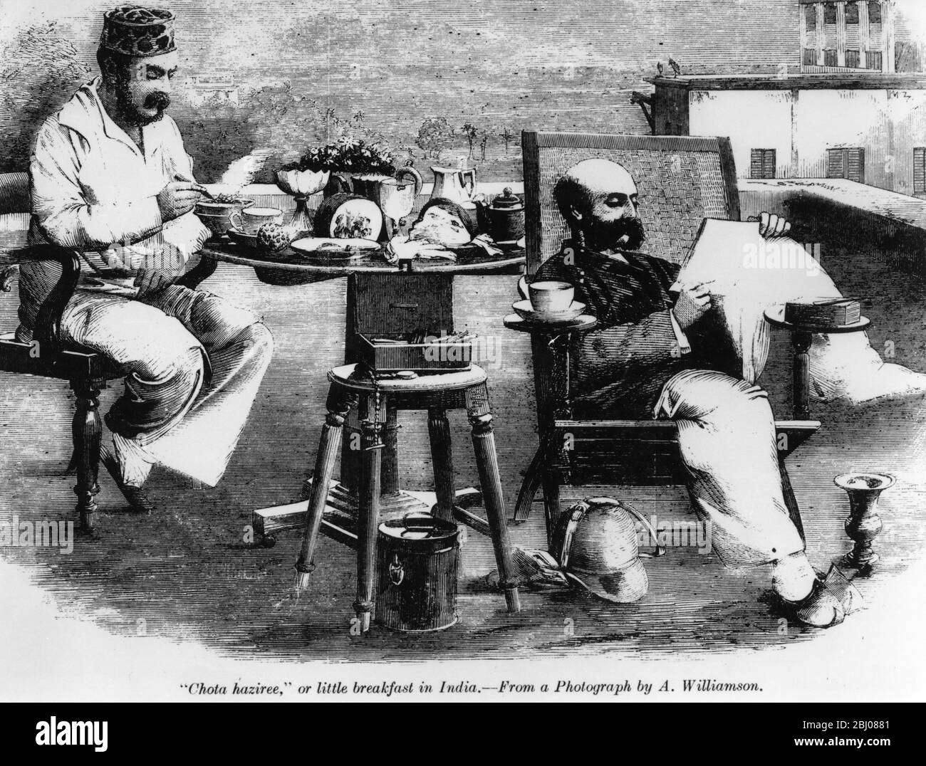 Chota haziree or a little breakfast in India, from a photograph by A.Williamson. Two men having breakfast on a terrace, one relaxing and reading the newspaper. Stock Photo