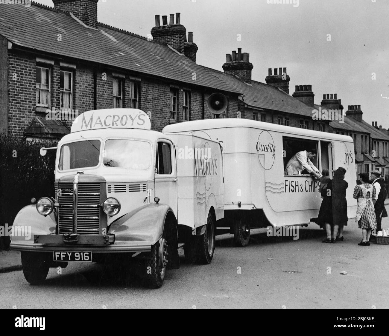 A travelling fish and chip shop for the villages. - This mammoth van, owned by H.C. Macroy, is now touring the villages of Kent so successfully that he has one more van in action and two more on order. Shown here serving to the locals of Hextable, Kent, England. - 23 March 1948 Stock Photo