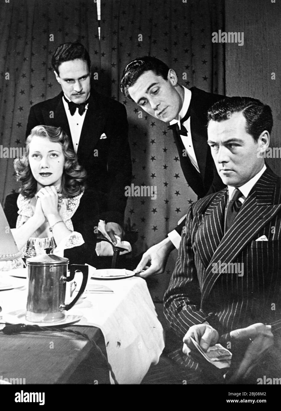 A man wants to impress his lady friend but two waiters produce the bill to the couple after dinner and the male diner was only intending to tip one. What does he do? - 21 February 1948 Stock Photo