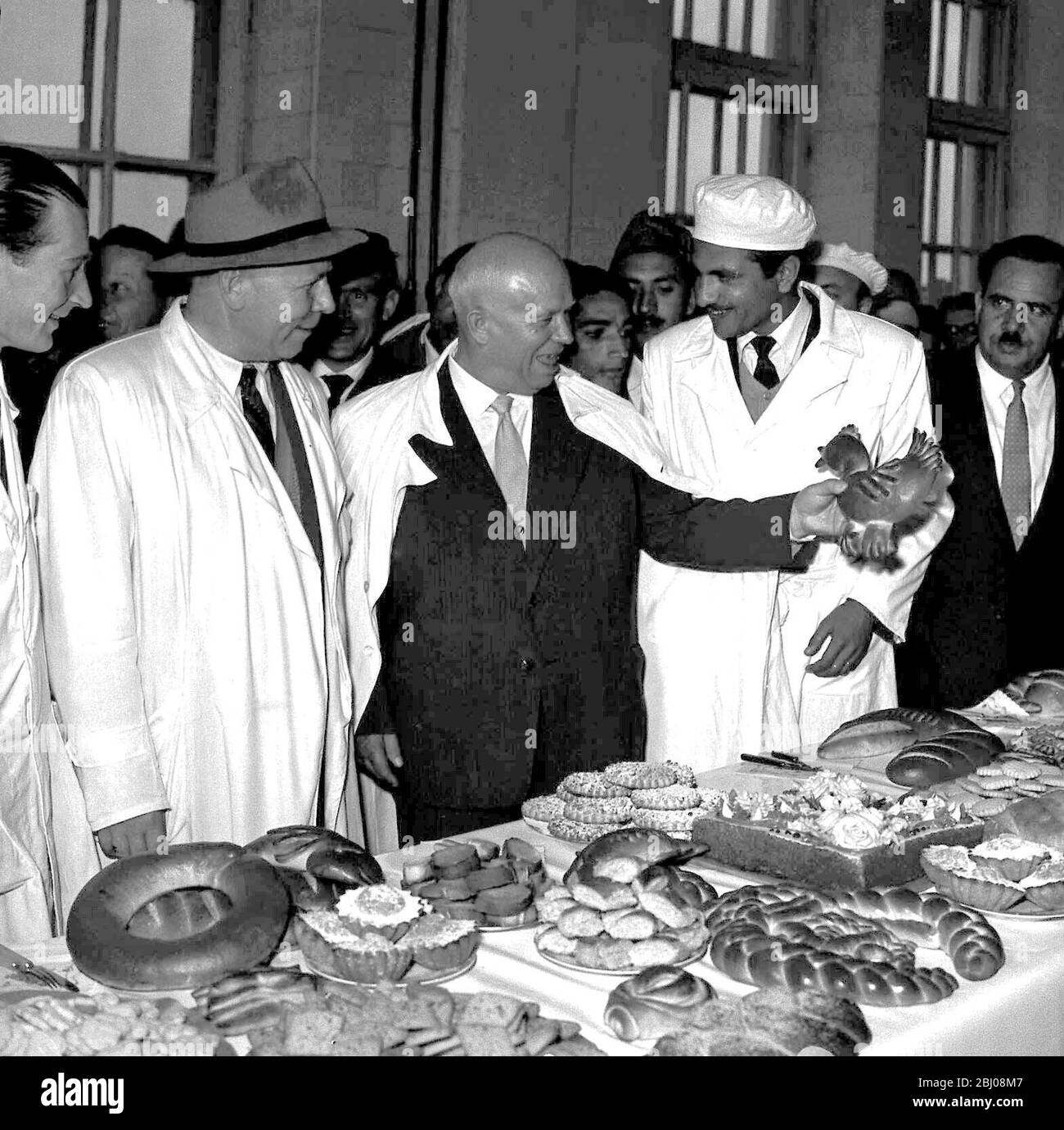 Fancy bread for Khrushchev. Kabul, Afghanistan. Soviet Premier Nikita S Khrushchev chuckles as he holds up a hen-shaped pastry, when he toured Kabul bakery, which was built with Russian aid and technical supervision. The premier was visiting Afghanistan during his tour of Asian countries. 7th March 1960. Stock Photo