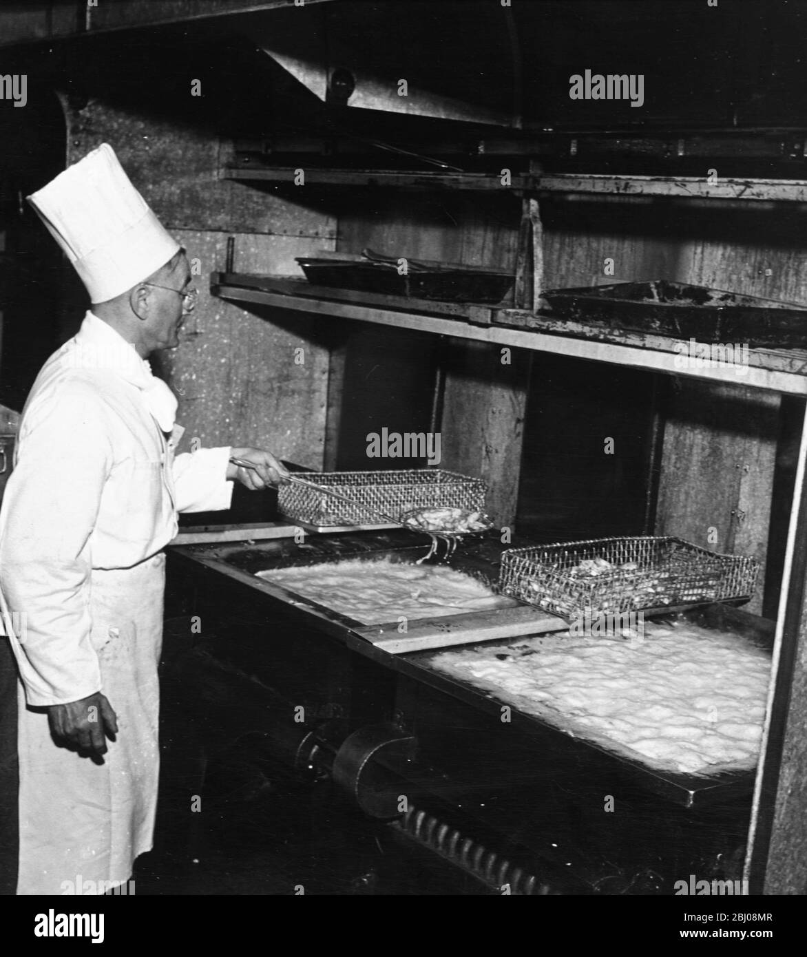 The chipped potatoes, or chips, is one of Britain's great favourites and are sent down from the vegetable kitchen raw to be fried on the various restaurant floors immediately before serving. - undated Stock Photo