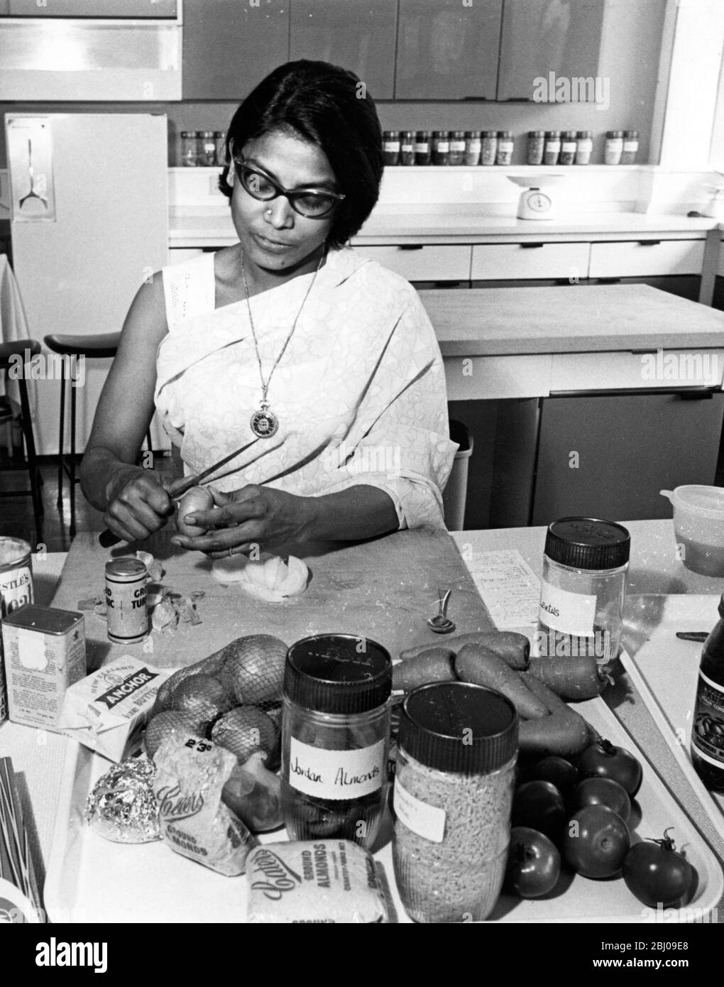 Mrs Mariyam Harris , from Hyderabad in India , cooks a dish from  Recipes for Asians in Britain  , in The Food Information Centre kitchen Stock Photo